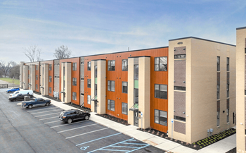 an exterior view of a building with a parking lot